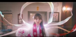 Head Over Heels Kdrama showing female lead in traditional hanbok with magical ribbons glowing around her during a shaman ritual scene.
